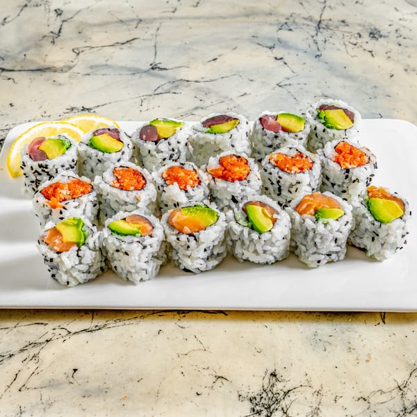 A white plate holds various Wasabi Sushi rolls with tuna, salmon, avocado, and roe fillings.